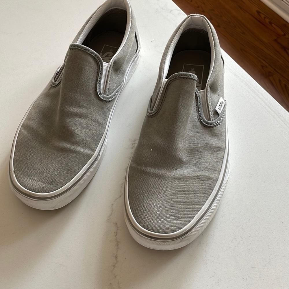 Light grey slip on vans.